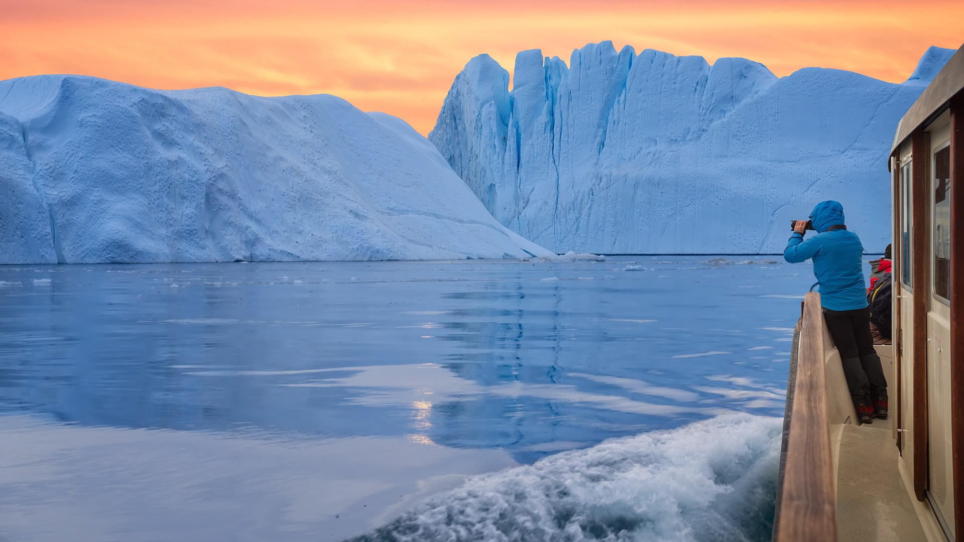 Photographing an iceberg from a boat near Ilulissat, Greenland