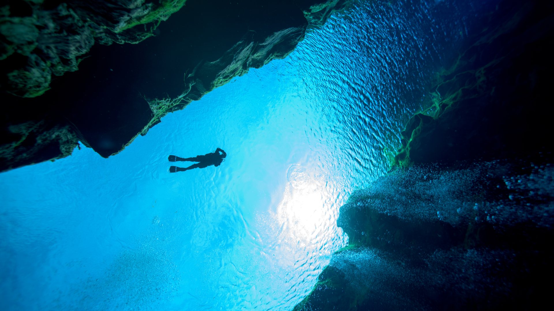 Person snorkelling at Silfra, South Iceland