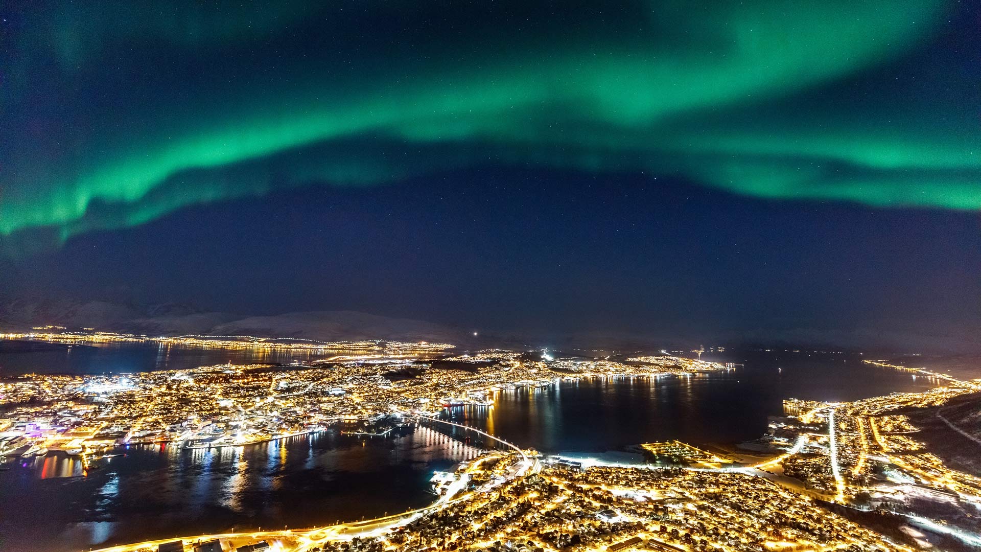 Aerial view of Tromso at night and Northern lights