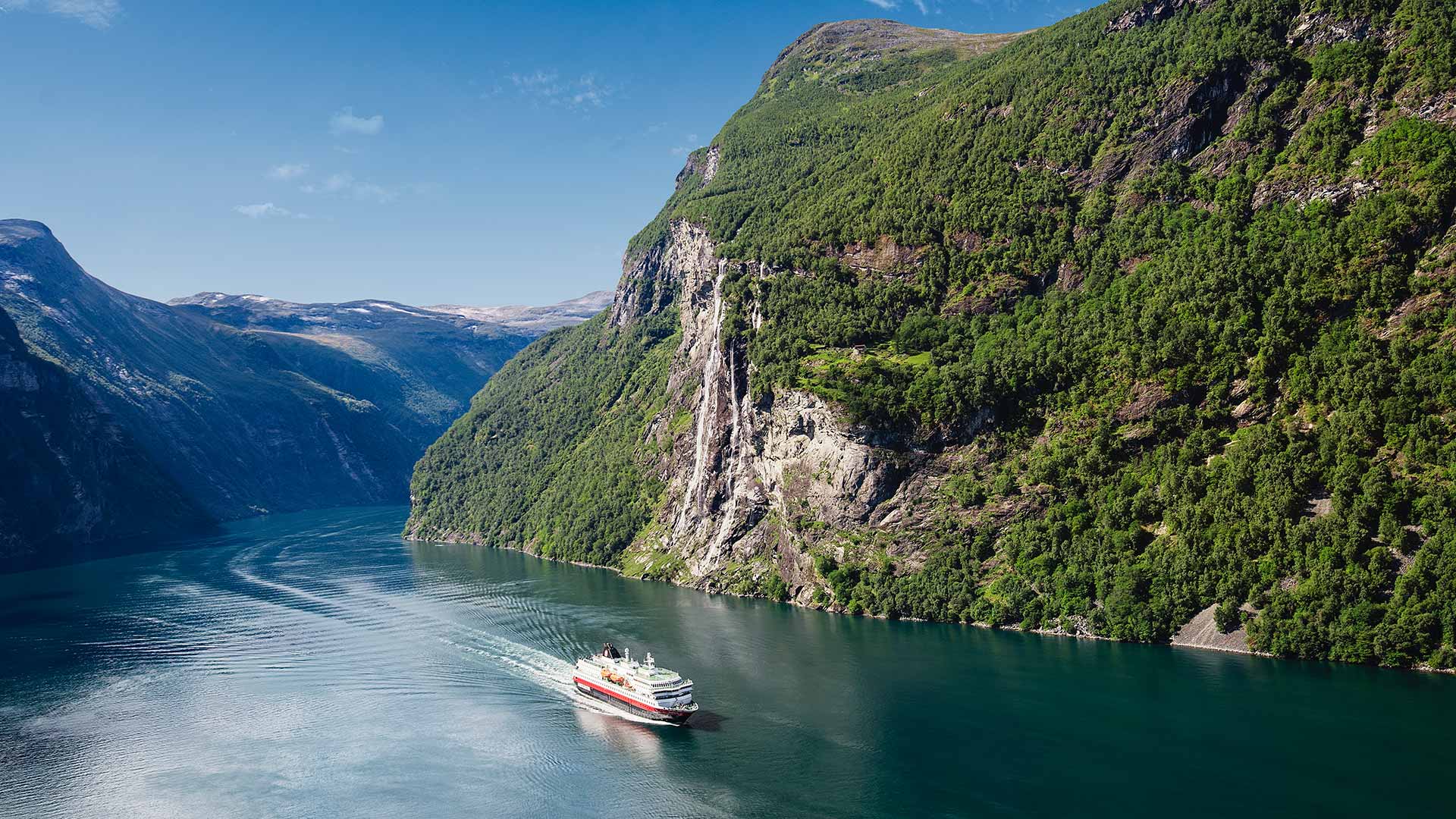 hurtigruten ship sailing on fjord